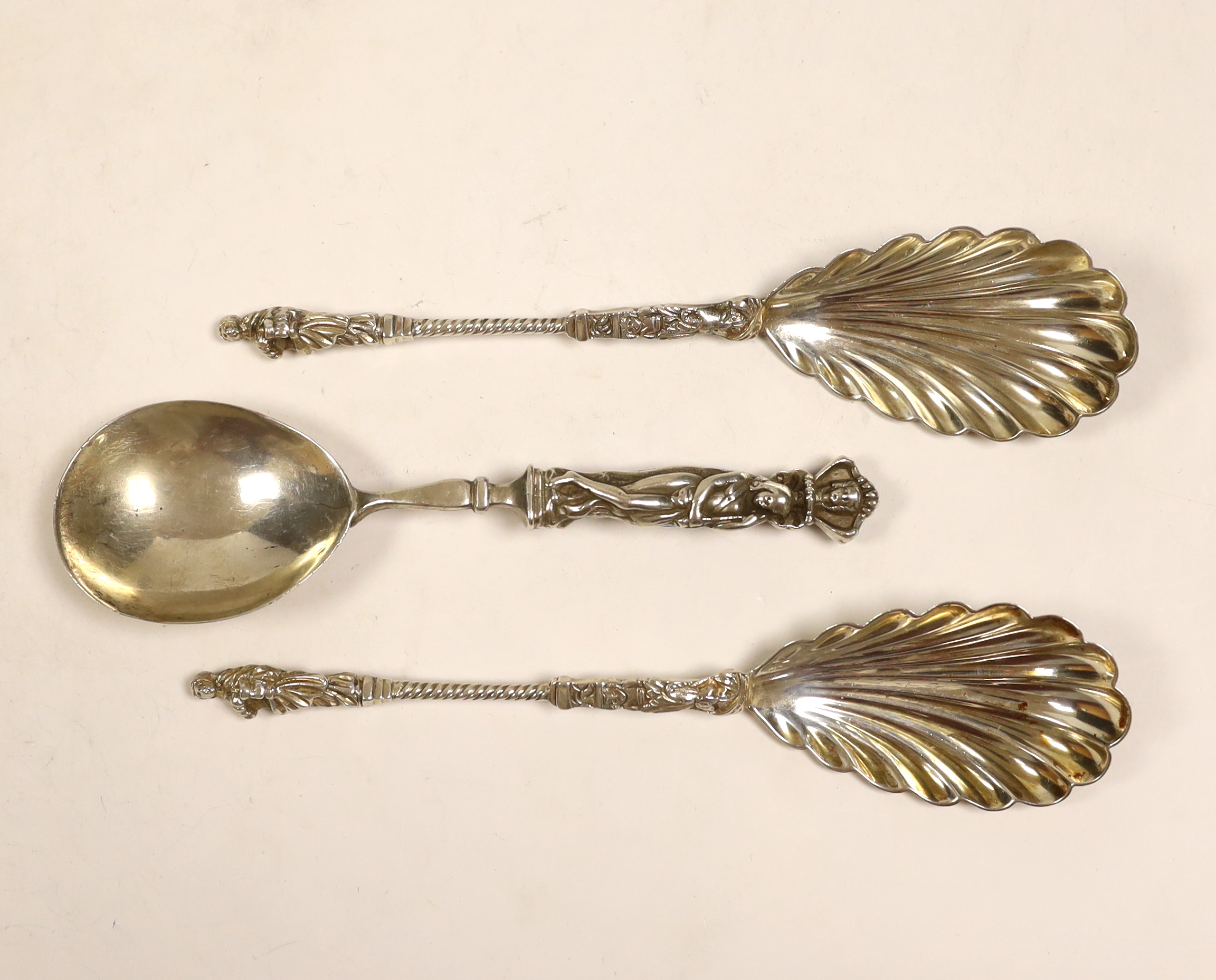 A pair of late Victorian silver apostle spoons with shall bowls, Edward Hutton, London, 1891, 20.3cm and a similar French? white metal spoon.